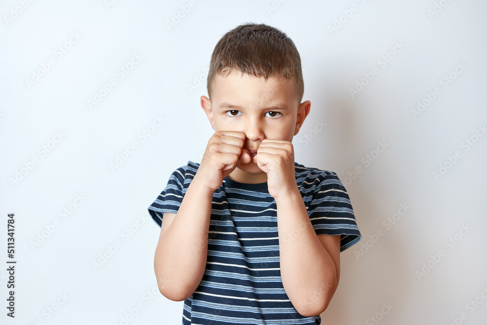 Little boy in a boxing rack with a stern expression. Little boy in a boxing rack with a stern expression.