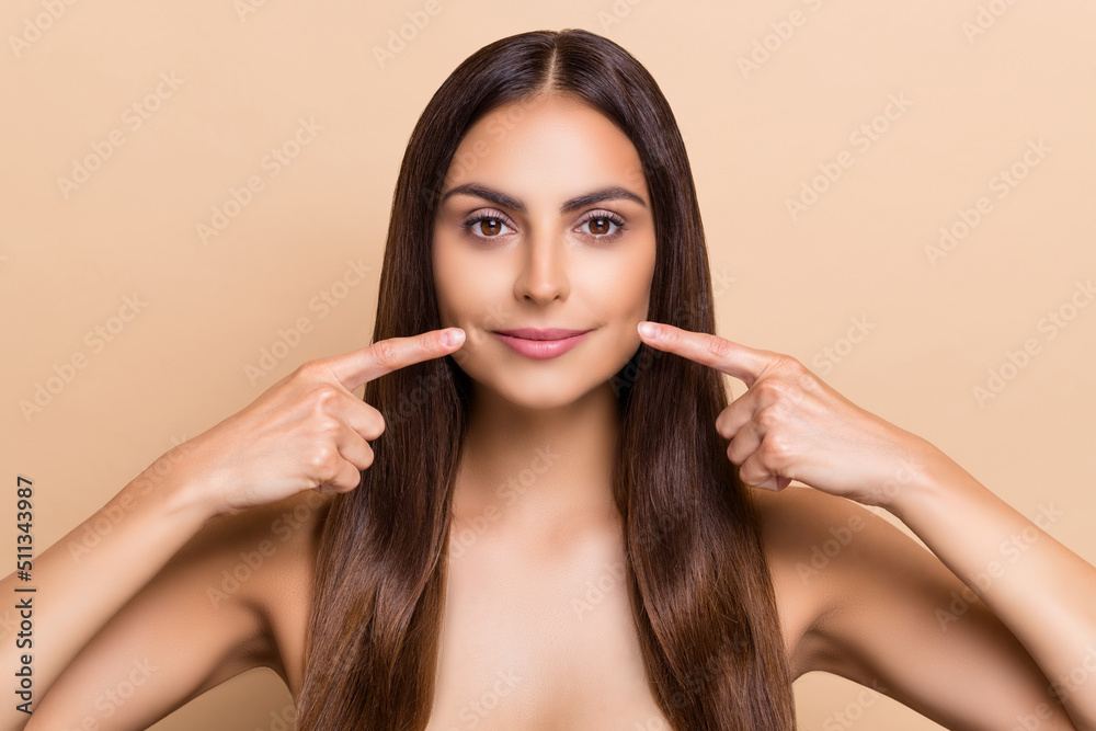 Portrait of attractive cheery long-haired girl demonstrating perfect lips isolated over beige pastel color background Portrait of attractive cheery long-haired girl demonstrating perfect lips isolated over beige pastel color background