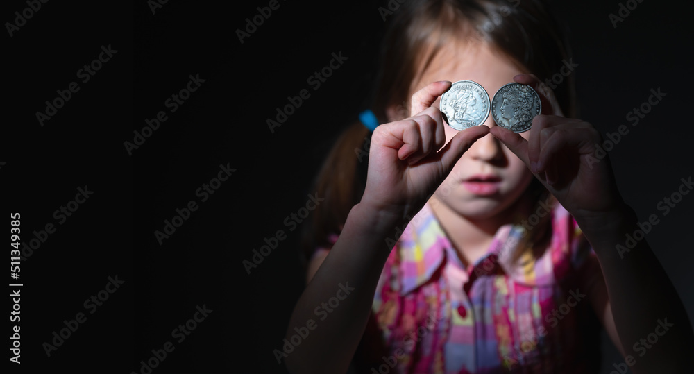 US Dollar coins in front of eye as symbol of love to money and strong motivation. Copy space for text. US Dollar coins in front of eye as symbol of love to money and strong motivation. Copy space for text.