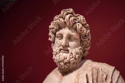 Portrait of a Statue of the Greek god of healthcare, medicine and healing - Asclepius. Antique art and culture photo
