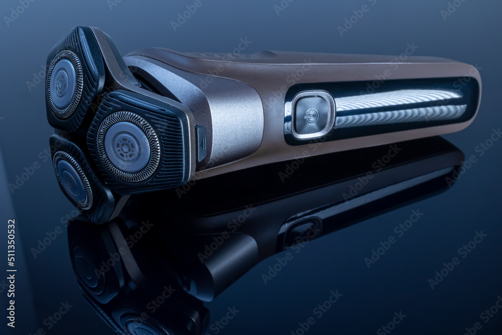 Fotografie Electric shaver closeup on black background