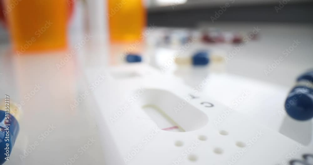 Covid 19 test and capsules on the table, shallow focus Covid 19 test and capsules on the table, shallow focus