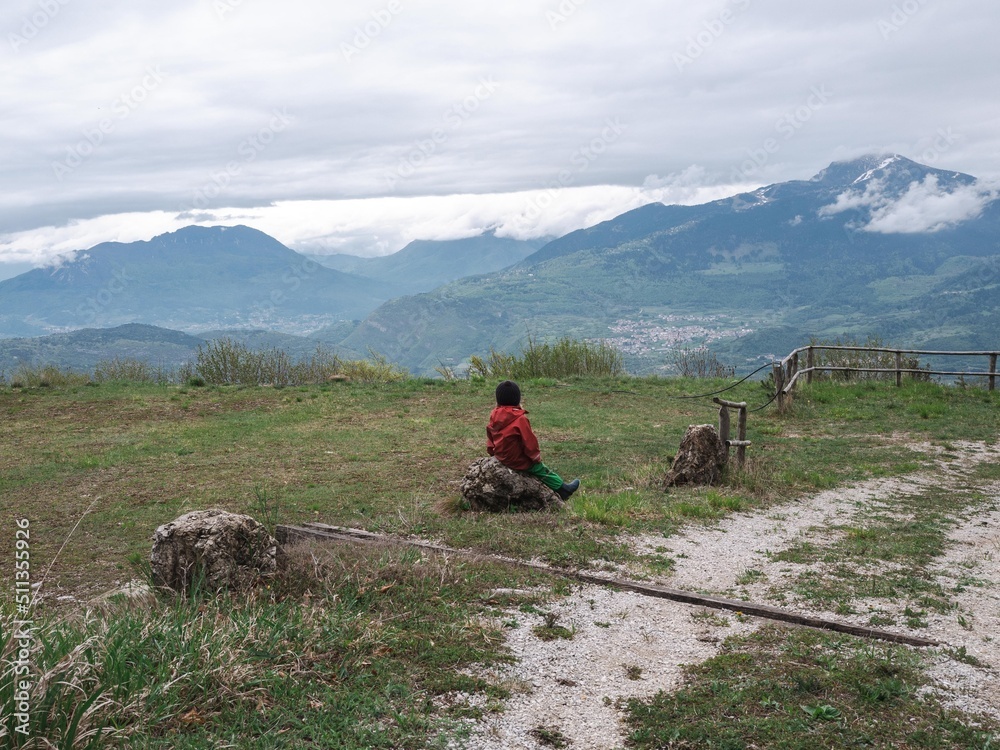 A child looks out over the Dolomites, Italy. 