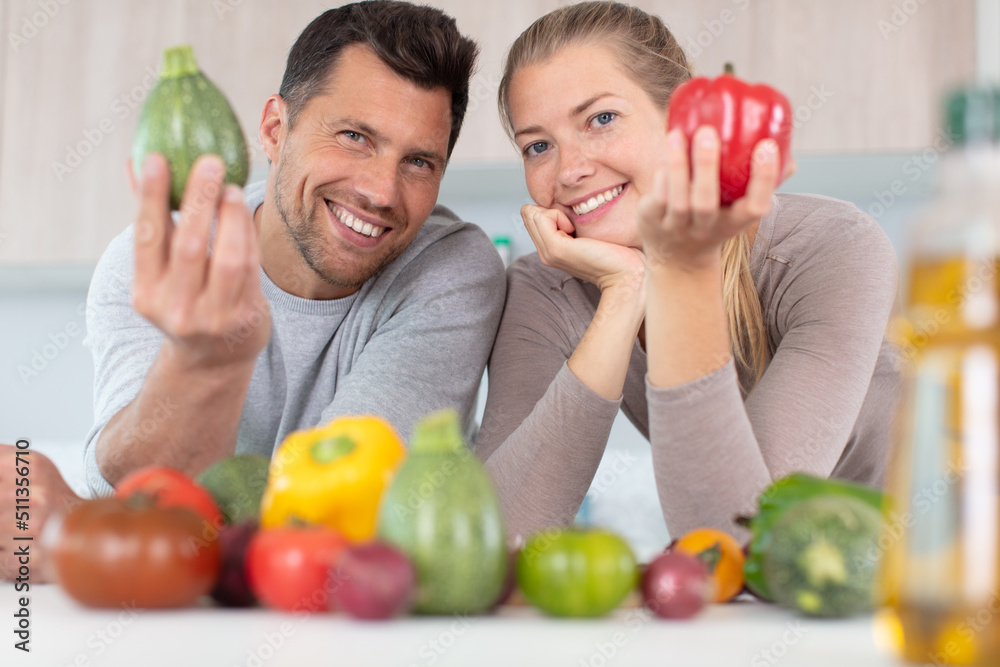 Fototapeta premium a happy couple holding peppers