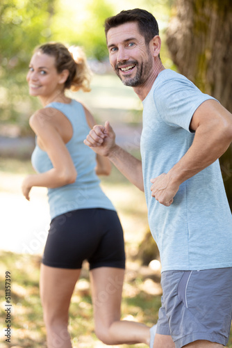 Fototapeta Naklejka Na Ścianę i Meble -  couple jogging and running outdoors in nature