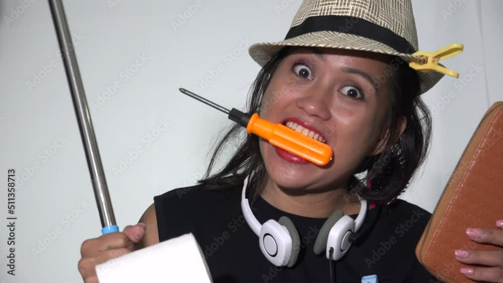 A Funny Woman Holding Household Objects A Funny Woman Holding Household Objects