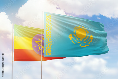 Sunny blue sky and flags of kazakhstan and ethiopia