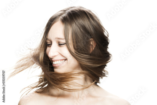 brunette girl with flowing hair in the air studio portrait against white background...