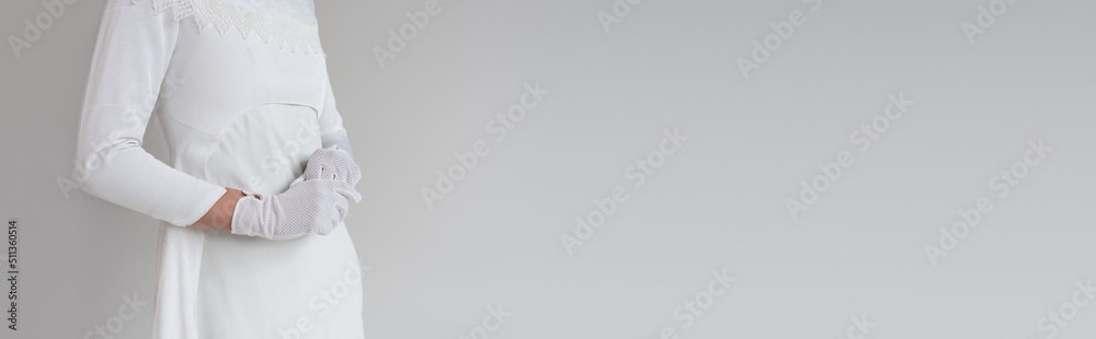 Fototapeta premium cropped view of woman in gloves and wedding dress isolated on grey, banner.