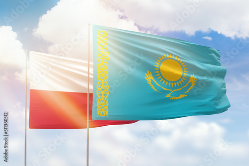 Photos Sunny blue sky and flags of kazakhstan and poland
