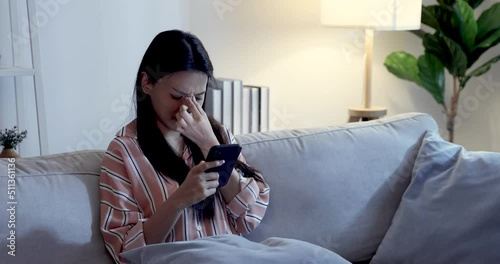 Tired Asian woman suffering eyestrain using mobile phone, Blue light is harmful to eyes.	
