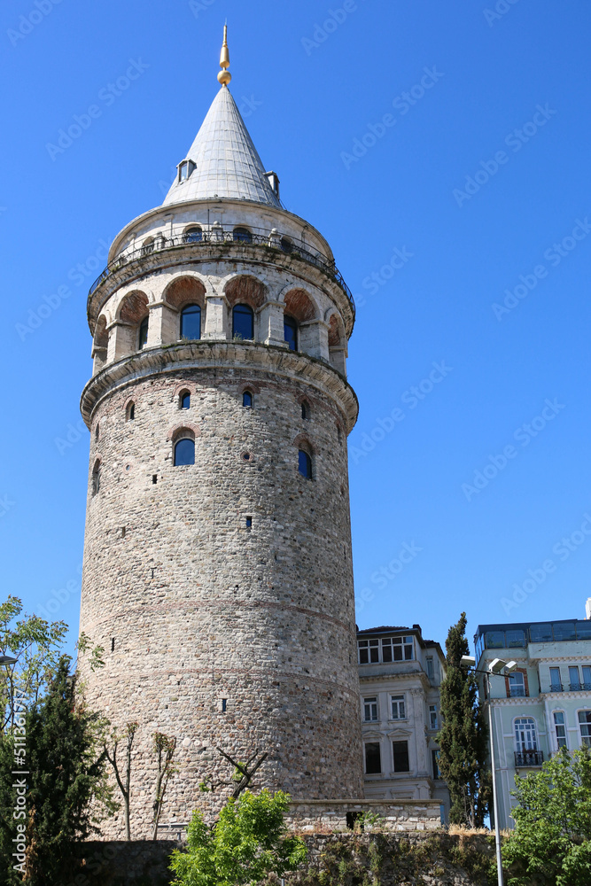 Galata Tower, medieval stone tower in Istanbul, Turkey, in the foreground on a sunny day