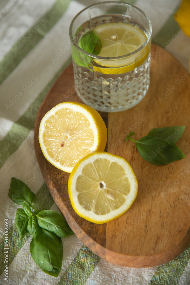 The ingredients for lemonade are on the table: lemons, lime, mint, sugar. A glass and a decanter of a refreshing summer seasonal drink. Making a drink at home. The ingredients for lemonade are on the table: lemons, lime, mint, sugar. A glass and a decanter of a refreshing summer seasonal drink. Making a drink at home.