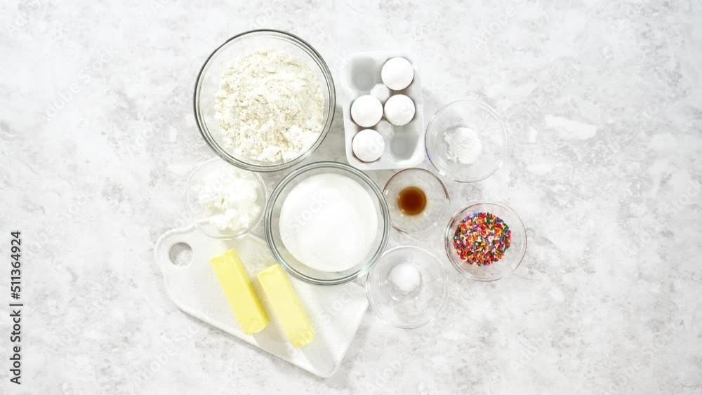 Flat lay. Ingredients in glass mixing bowls to bake funfettti bundt cake. Flat lay. Ingredients in glass mixing bowls to bake funfettti bundt cake.