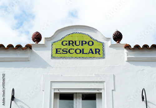 Letrero de azulejos de grupo escolar con fondo verde en una escuela de enseñanza primaria de Andalucía, España. Mosaico de azulejos con letras azules sobre fondo verde y orla. photo