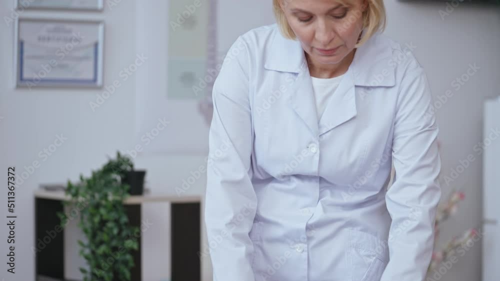 Doctor examining patient's knee in hospital, arthritis treatment, rehabilitation Doctor examining patient's knee in hospital, arthritis treatment, rehabilitation