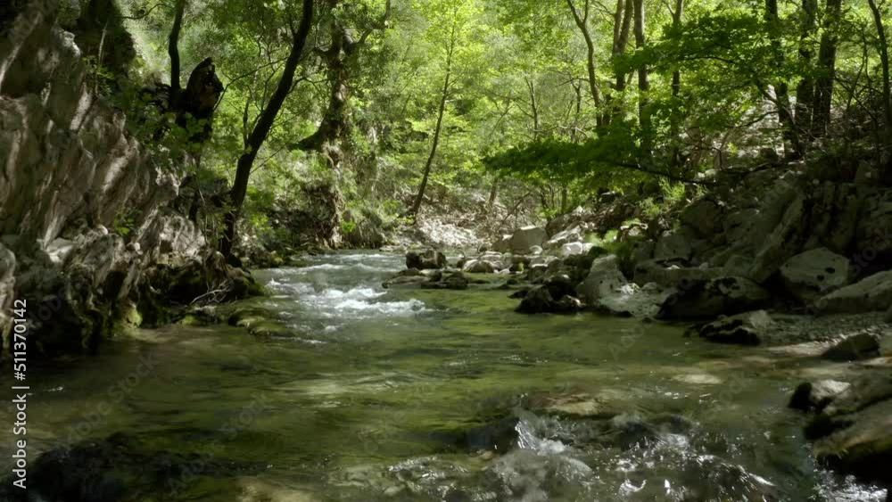 Drone flying over a beautiful clear mountain stream in the woods - untouched environment Drone flying over a beautiful clear mountain stream in the woods - untouched environment