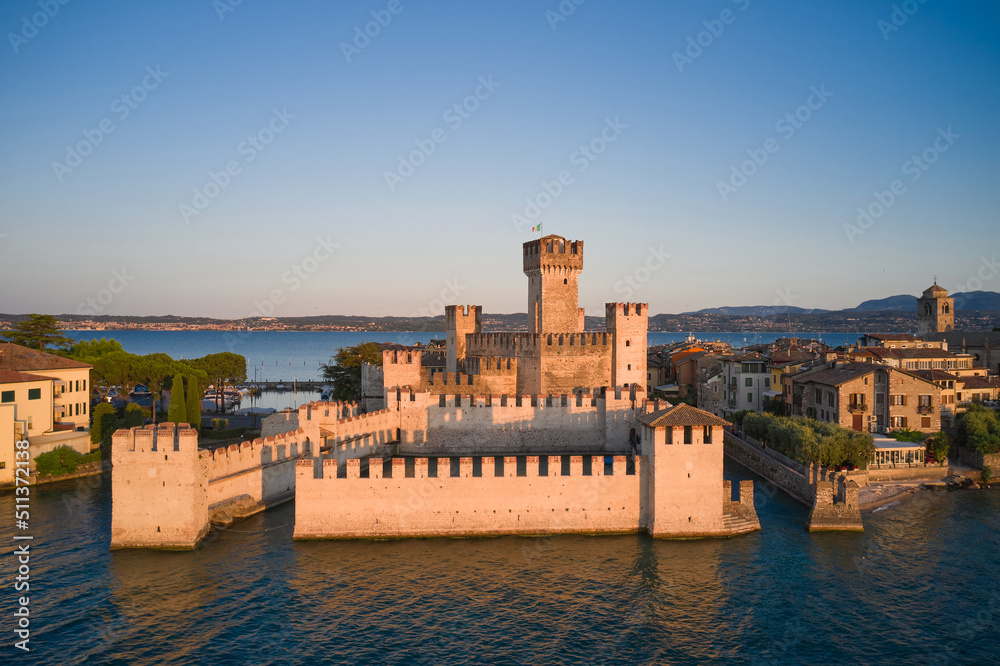 Sirmione, Lake Garda at sunrise. Sirmione castle in Italy at sunrise aerial view.