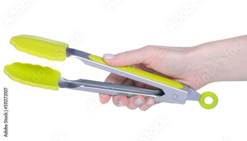 Green kitchen tongs in hand on white background isolation photo