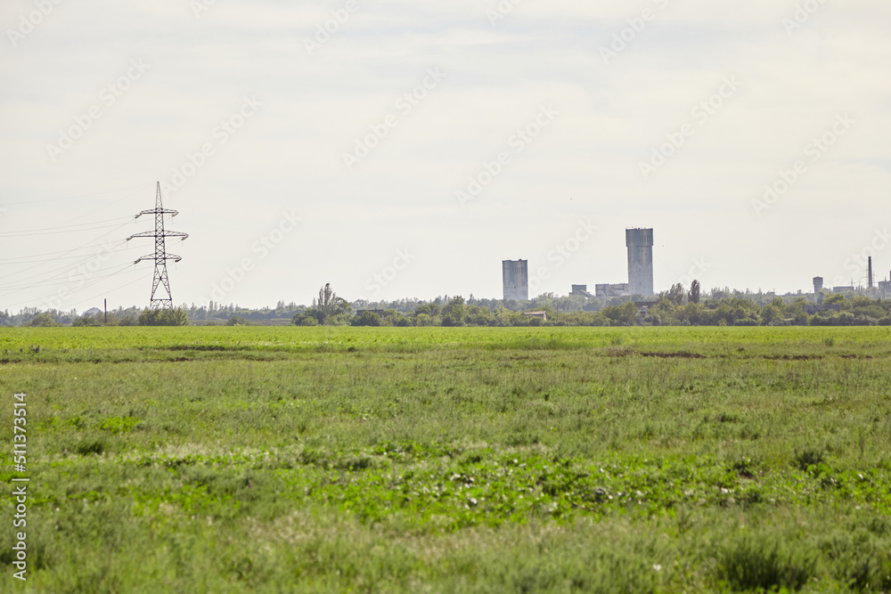 Green meadow.  Mine pile driver on horizon