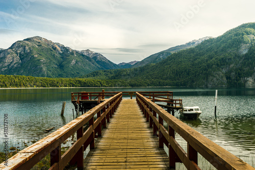 Wooden pier on a beautiful lake and the Andes mountain range in the background. Alerces National Park. Chubut, Argentina