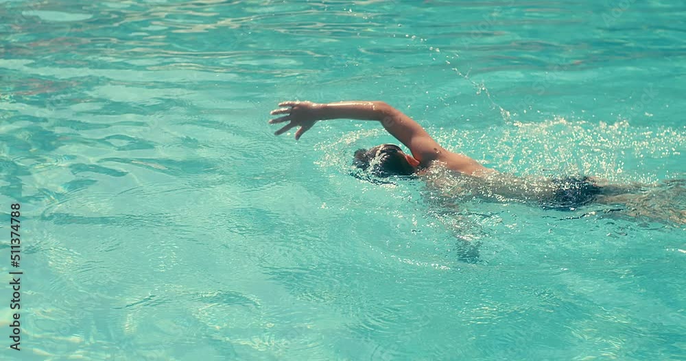 Child swim in the pool, sunbathes, swimming in hot summer day. Relax, Travel, Holidays, Freedom concept. 4K slow motion Child swim in the pool, sunbathes, swimming in hot summer day. Relax, Travel, Holidays, Freedom concept. 4K slow motion