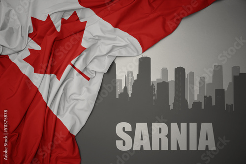 abstract silhouette of the city with text Sarnia near waving national flag of canada on a gray background. photo