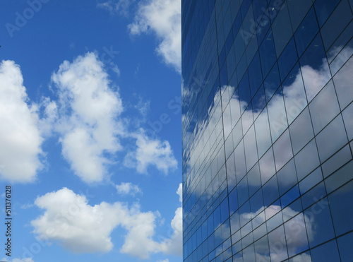 Canvas Print blue sky with clouds and a glass building reflecting them