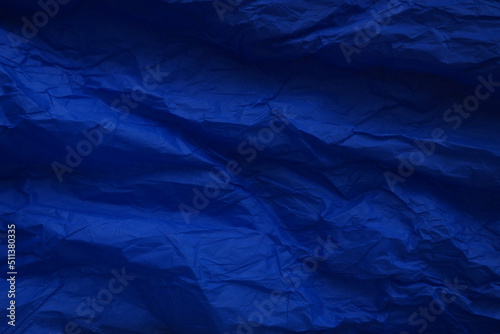 Dark blue crumpled paper background. Mysterious color cobalt