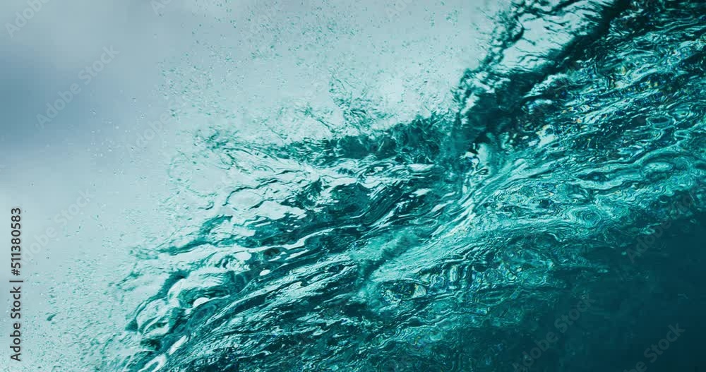 Stormy blue ocean wave breaking in ultra slow motion