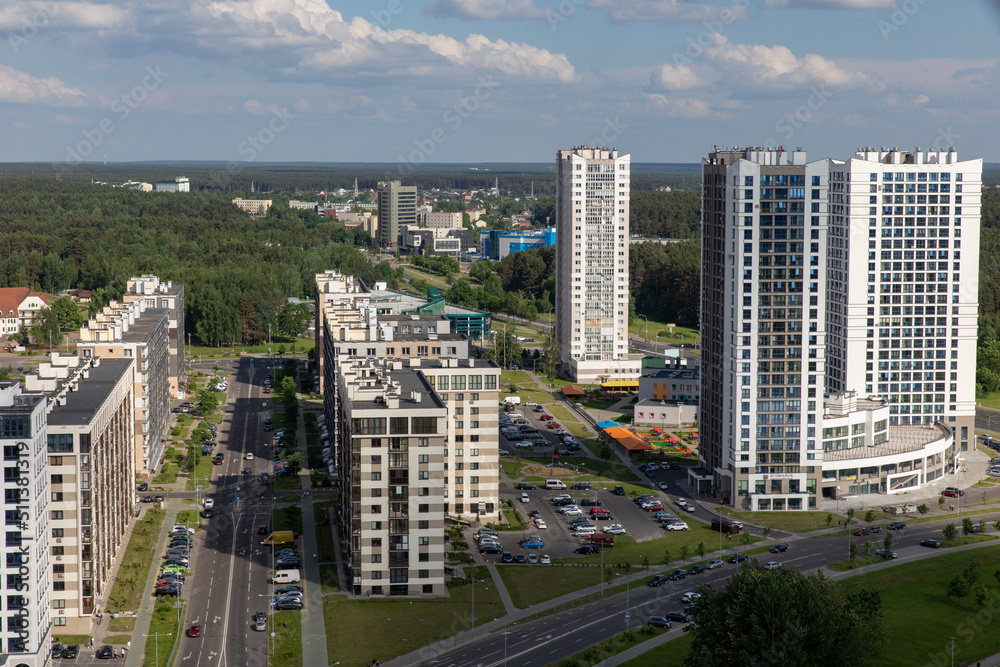 Fototapeta premium Landscape from the height of the city with beautiful modern houses in the summer afternoon. Belarus is the capital city of Minsk. Europe.