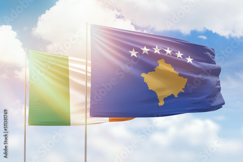 Sunny blue sky and flags of kosovo and ireland