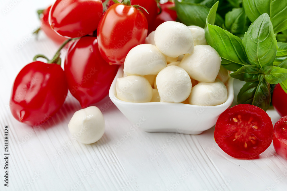 Mozzarella cheese with basil and tomatoes. Mozzarella cheese with basil and tomatoes.