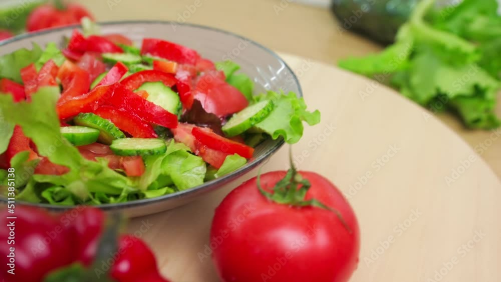 Fresh vegetable salad close up on a wooden tray slow motion. Fresh vegetable salad close up on a wooden tray slow motion.