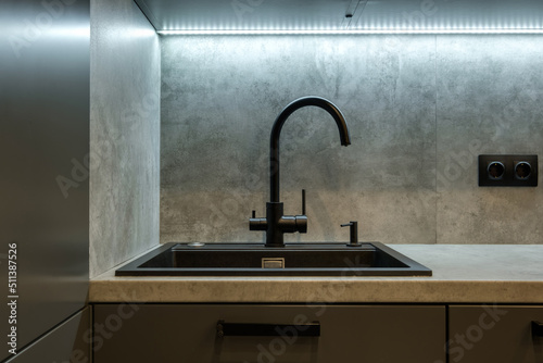 Black water tap sink with faucet in expensive kitchen