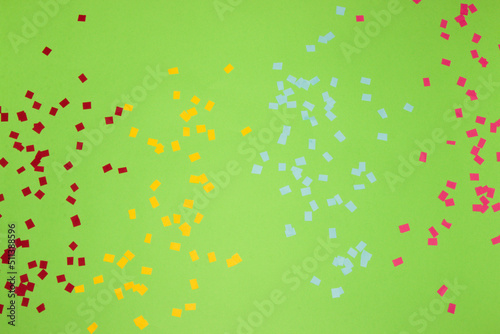 green background with chopped colorful part paper, creative summer design, party time