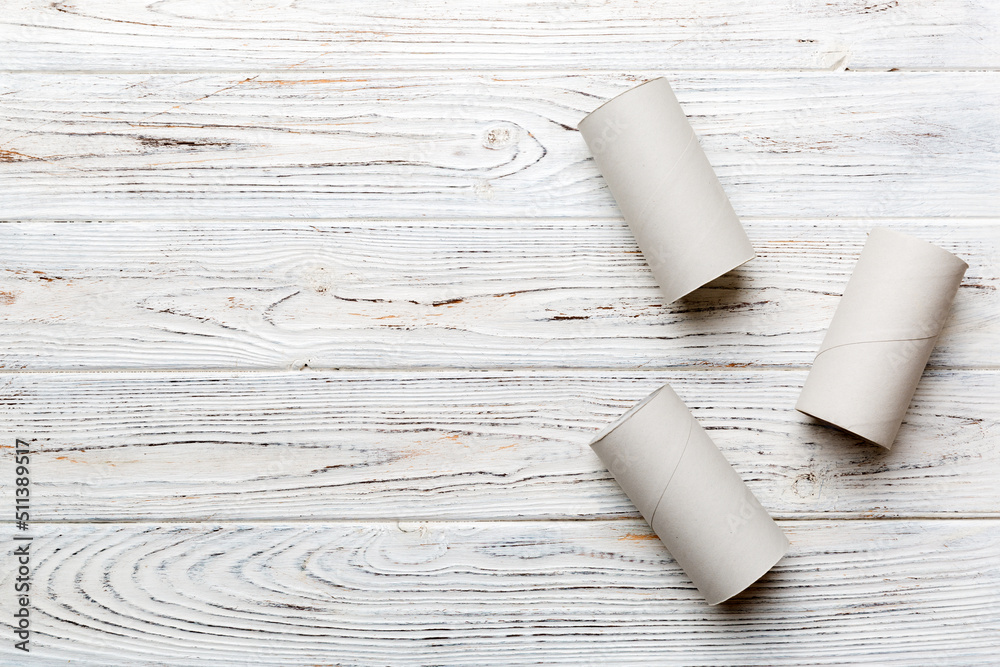 Flat lay composition with empty toilet paper rolls and space for text on color background. Recyclable paper tube with metal plug end made of kraft paper or cardboard Flat lay composition with empty toilet paper rolls and space for text on color background. Recyclable paper tube with metal plug end made of kraft paper or cardboard