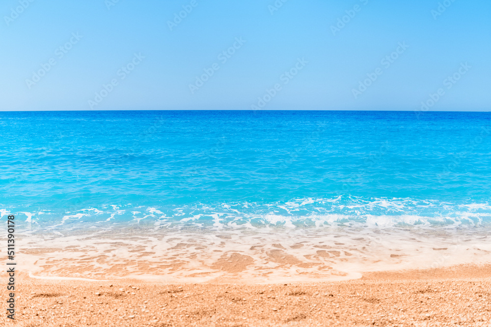 Wallpaper of turquoise sea, blue clear sky and sandy beach in a sunny summer day