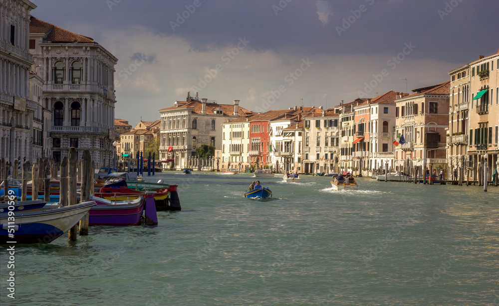 VENICE, ITALY - September 03, 2018: The Grand Canal seen from Rialto Bridge in the morning with boats sailing against typical buildings