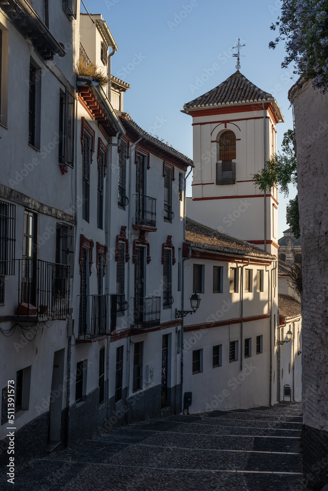 Typical white streets in the historic neighborhood of Albaicin in the city of Granada at sunset. Andalucia, Spain.