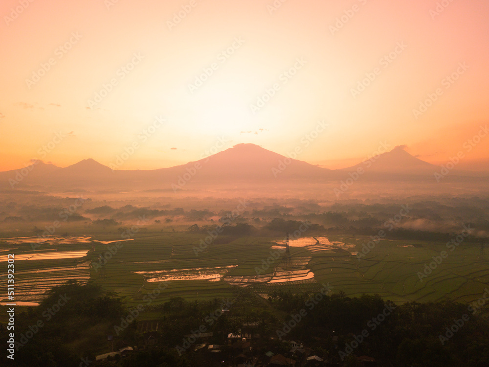 Drone photo of Sunrise sky with mountains on the countryside. Magelang, Central Java, Indonesia