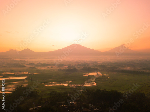 Drone photo of Sunrise sky with mountains on the countryside. Magelang, Central Java, Indonesia