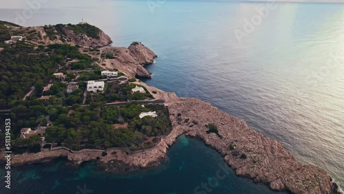 Early morning drone view of Platja de Cala Gat Beach with turquoise sea water. Spanish Town Es Pelats and Cala Ratjada from above in Majorca, Balearic Islands, Spain, drone view.  photo