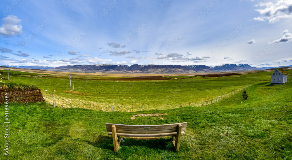 Beautiful Icelandic landscape. Bench facing the green meadow in Iceland Beautiful Icelandic landscape. Bench facing the green meadow in Iceland