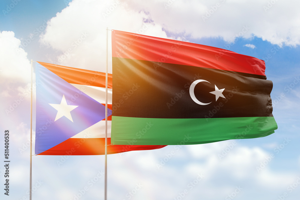 Sunny blue sky and flags of libya and puerto rico Sunny blue sky and flags of libya and puerto rico