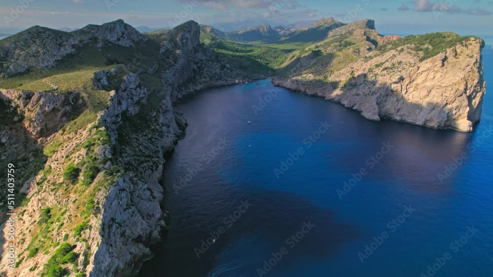 Rocky cliffs by the Mediterranean coastline of Majorca, Balearic Islands, Spain. Panoramic drone view of Cap Formentor in Serra de Tramuntana mountain region.