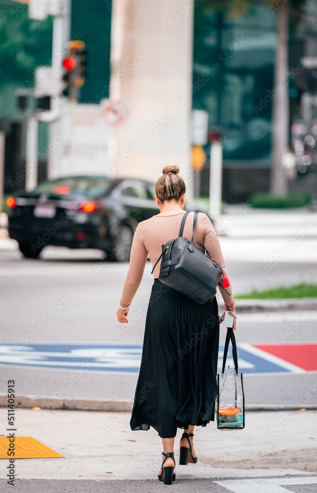 woman walking in the street cars traffic miami 