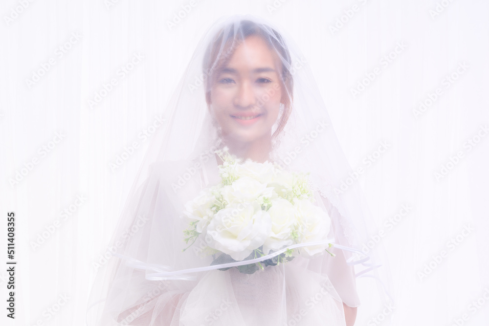 bride in white gown with veil holding flower bouquet bride in white gown with veil holding flower bouquet