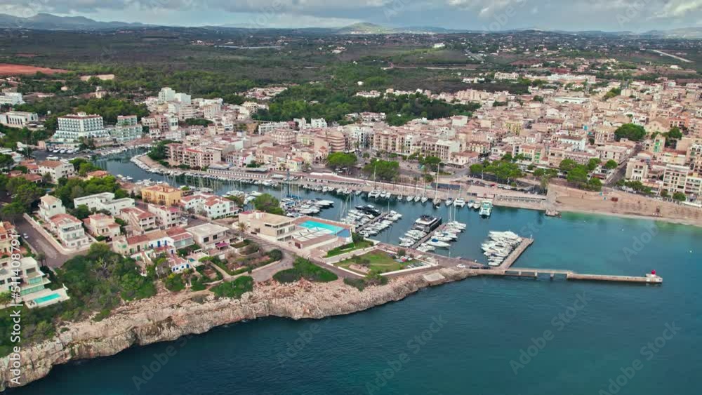 Scenic Porto Cristo Marina view from above with houses by the coast in Majorca. A view of a Spanish village known for amazing Drach Caves on the Balearic Islands, Spain. Scenic Porto Cristo Marina view from above with houses by the coast in Majorca. A view of a Spanish village known for amazing Drach Caves on the Balearic Islands, Spain.