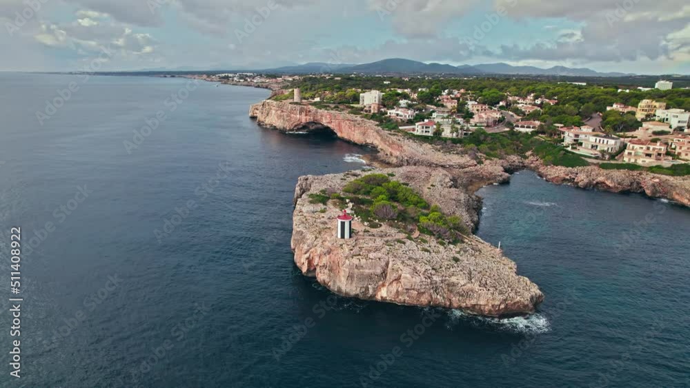 Beautiful view of coastal Porto Cristo village from above on Majorca Island. Torre del Serral dels Falcons by Drach Caves in Balearic Islands, Spain.